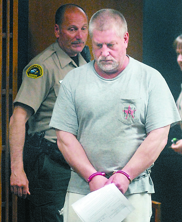 Barry A. Swegle enters Clallam County Superior Court on Monday. Behind him is court security officer John Beltrami. Keith Thorpe/Peninsula Daily News