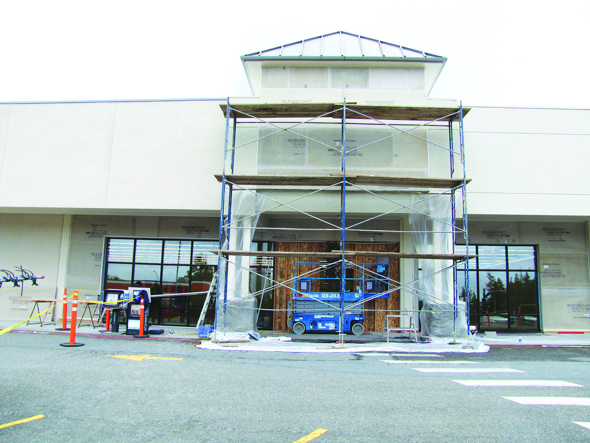 Workers at Port Angeles Plaza ready the facade of a storefront for the Big Lots sign. Arwyn Rice/Peninsula Daily News