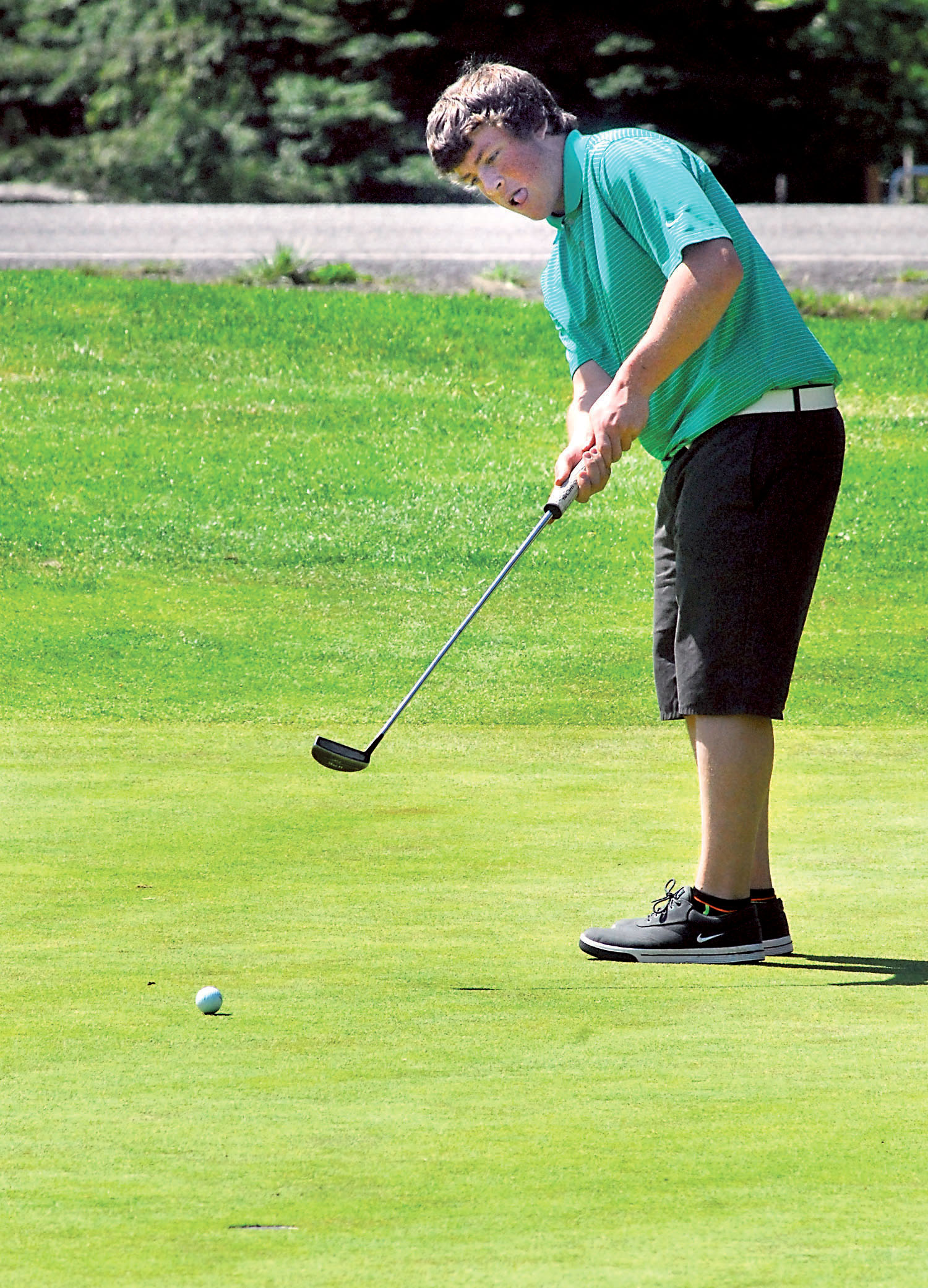 Alex Atwell of Port Angeles putts on the par-4 first hole during the Olympic League Championship at The Cedars at Dungeness in Sequim. Keith Thorpe/Peninsula Daily News