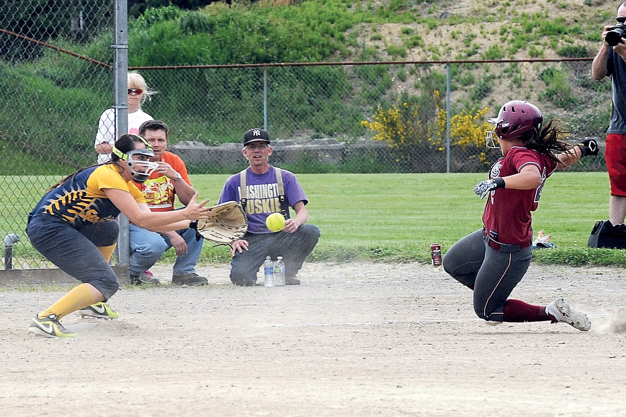 Forks third baseman Emily Klahn prepares to field a throw and tag the Hoquiam baserunner during the second game of a doubleheader with the Grizzlies. Hoquiam won both games