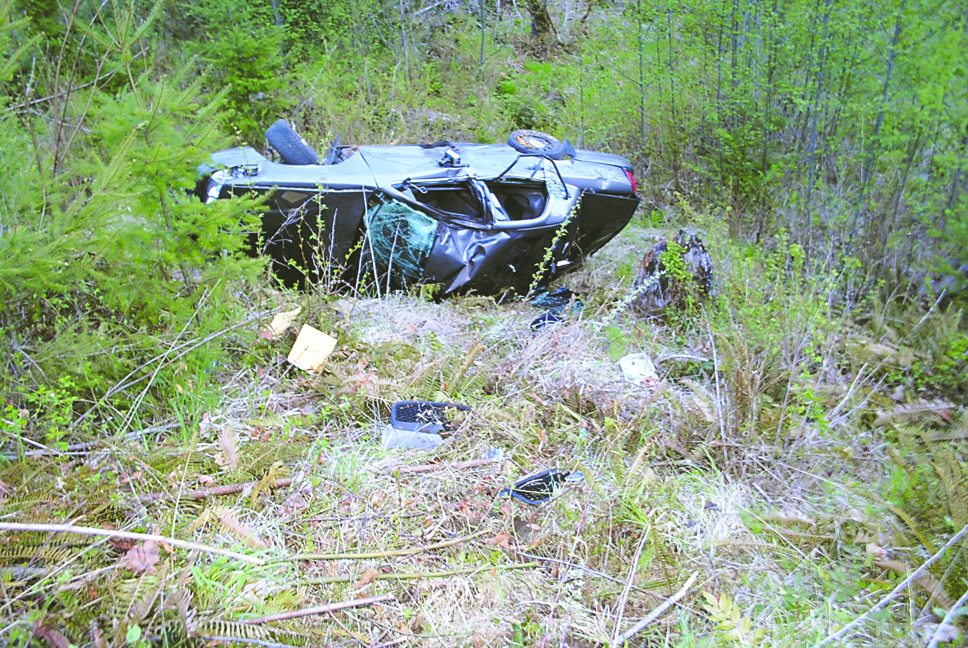 Trooper Travis Beebe's car is seen after it went down the ravine after motorcyclist Bjorn Larsen off Deer Park Road in 2012. Washington State Patrol