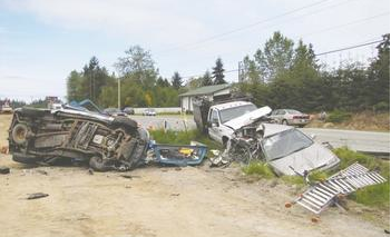 The three vehicles involved in last Monday morning's fatal crash sit on the south side of U.S. Highway 101 near Dryke Road west of Sequim. Arwyn Rice/Peninsula Daily News