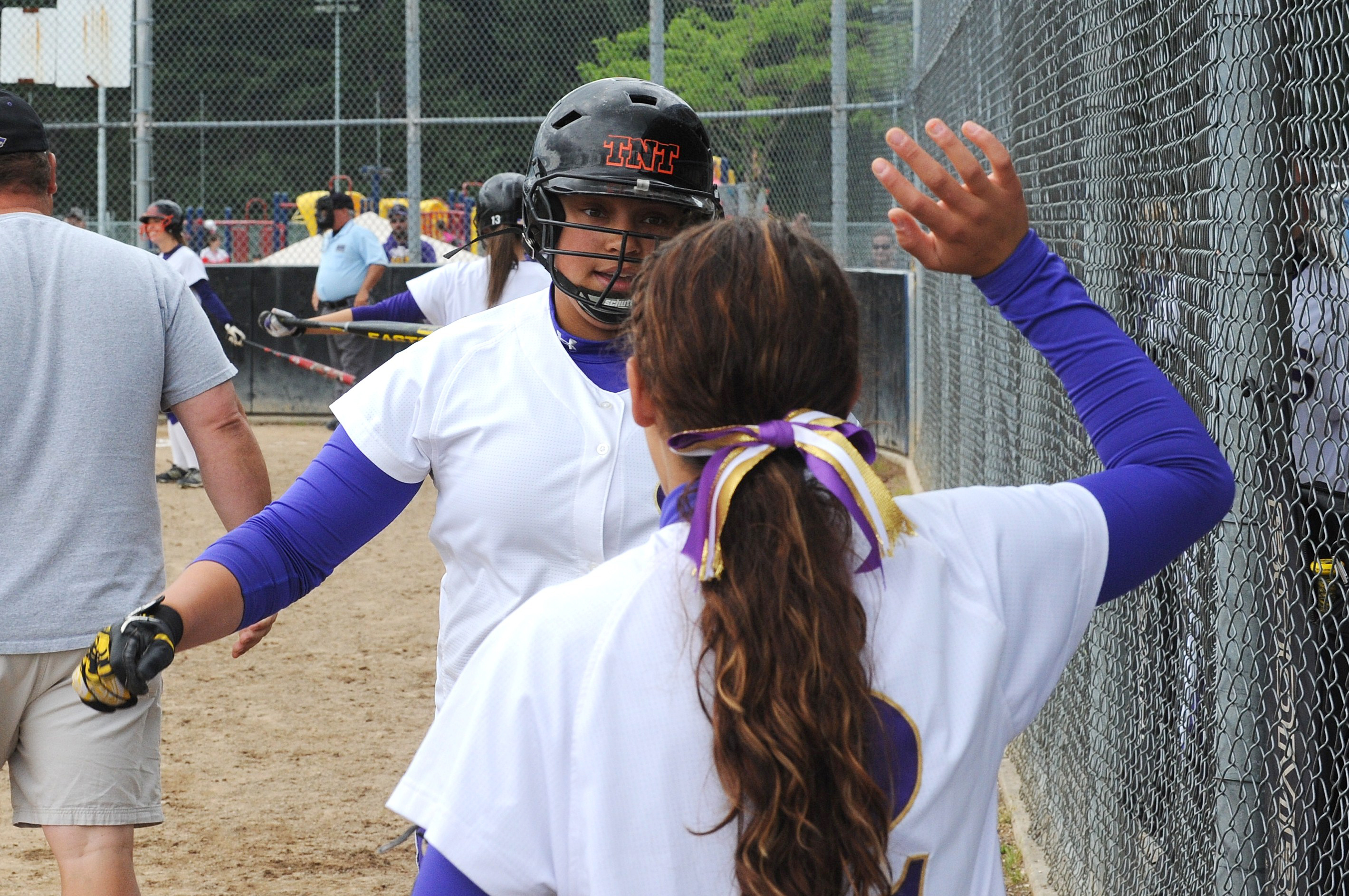 Sequim's Alexas Besand is congratulated by teammate McKayla Bentz after hitting home run in the Wolves' 10-0 win over Bremerton that earned them a berth in the state tournament. Lonnie Archibald/for Peninsula Daily News