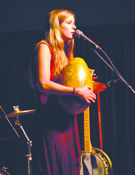 Katelyn Shook of the Shook Twins plays her signature golden egg as a percussion instrument Friday during the Juan de Fuca Festival of the Arts in Port Angeles. Sara Lindquist/for Peninsula Daily News