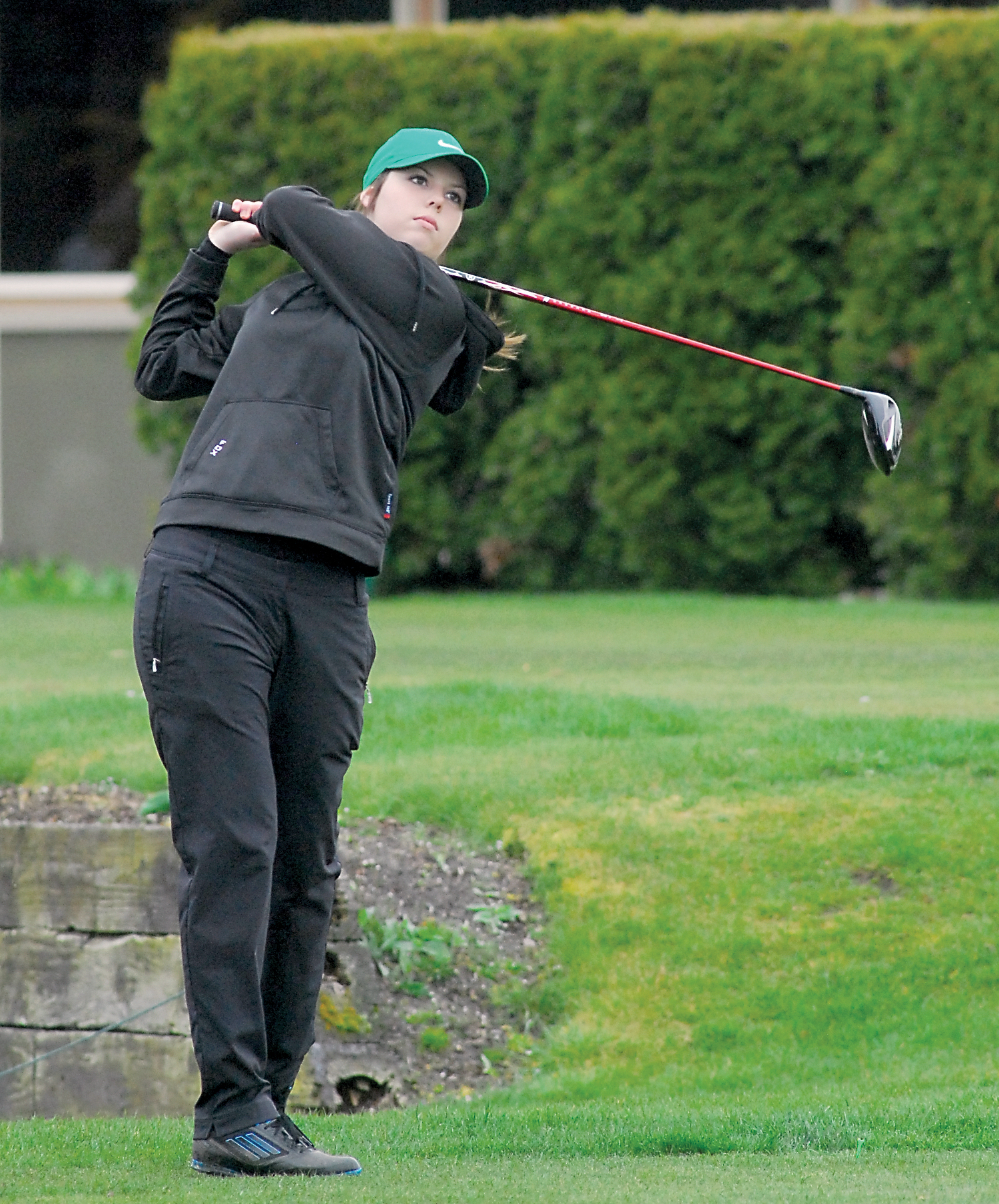 Dana Fox of Port Angeles tees off at Cedars at Dungeness earlier this season. Fox