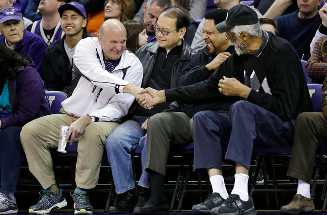 Steve Ballmer greeting the ex-NBA star Bill Russell at a college game in January. Ballmer is estimated to be worth $20 billion. The Associated Press