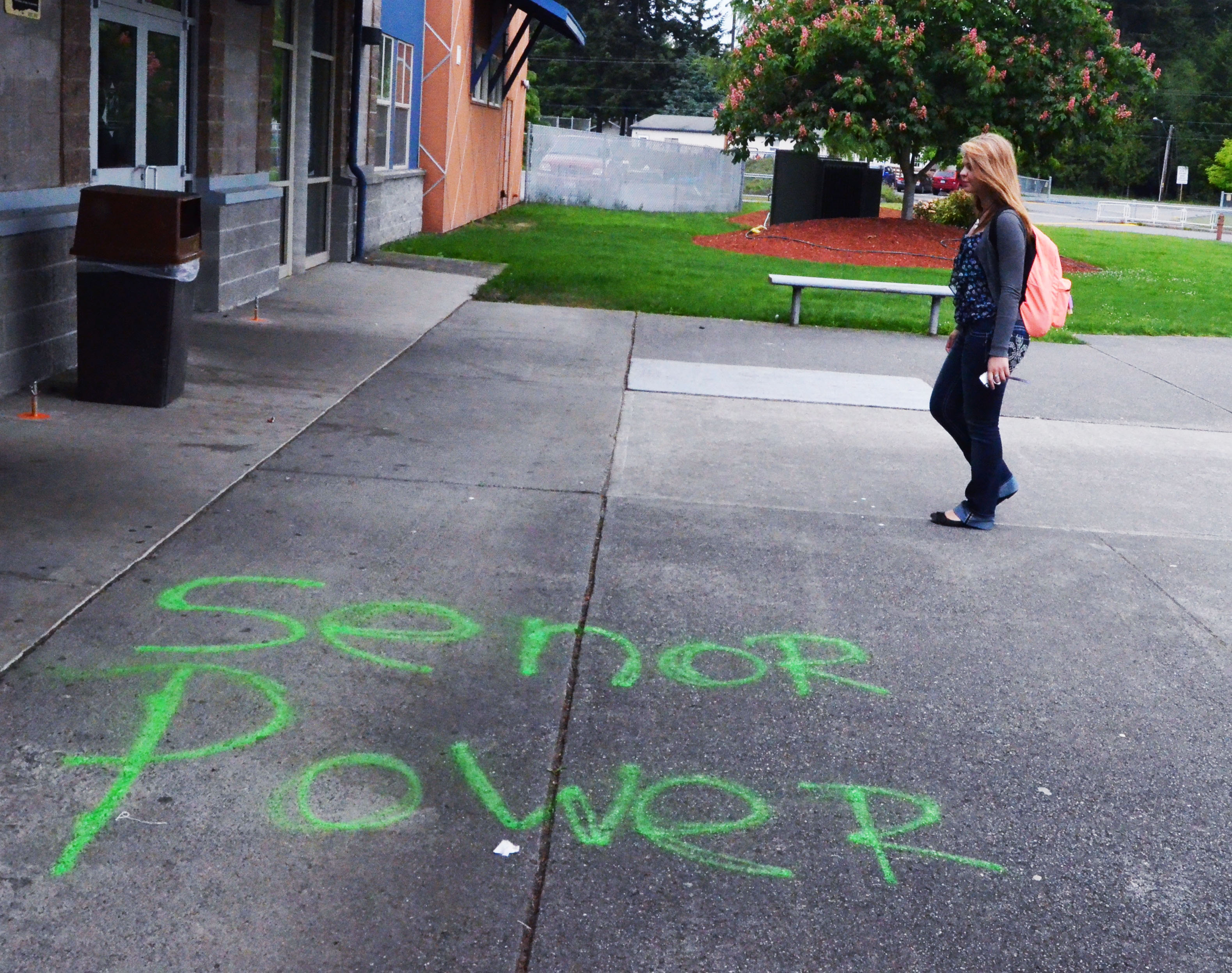 Chimacum High School student Cara Pace walks past graffiti that was left over the weekend