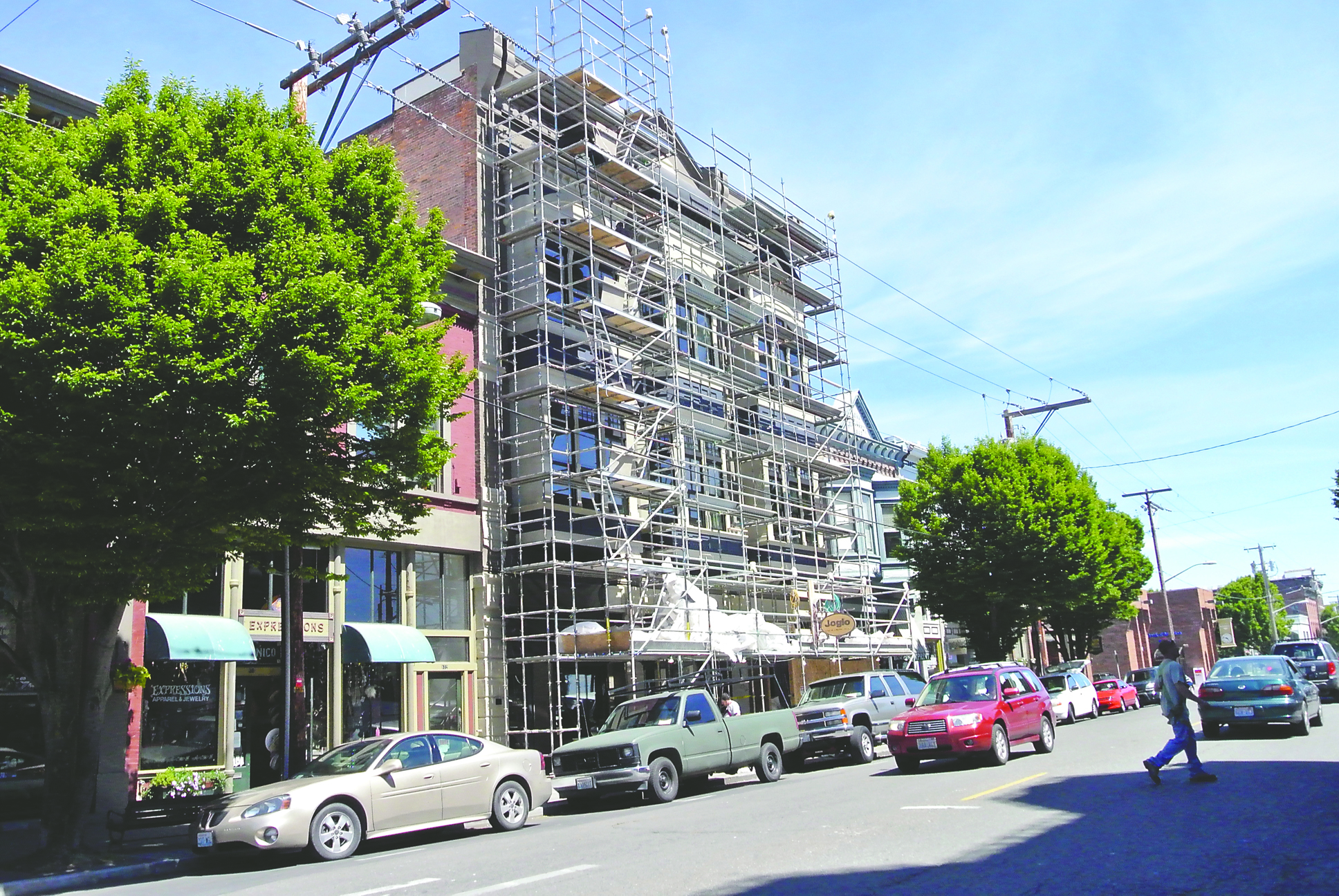 The white plastic construction shroud came off the Eisenbeis Building in Port Townsend on Tuesday. The scaffolding leaves this week. Charlie Bermant/Peninsula Daily News