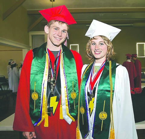 Michael Shively and Nakaia Maconber-Millman display their ASB President's Club stoles and other awards while waiting for the start of the Port Townsend High School commencement in McCurdy Pavilion at Fort Worden State Park on Friday. Steve Mullensky/for Peninsula Daily News