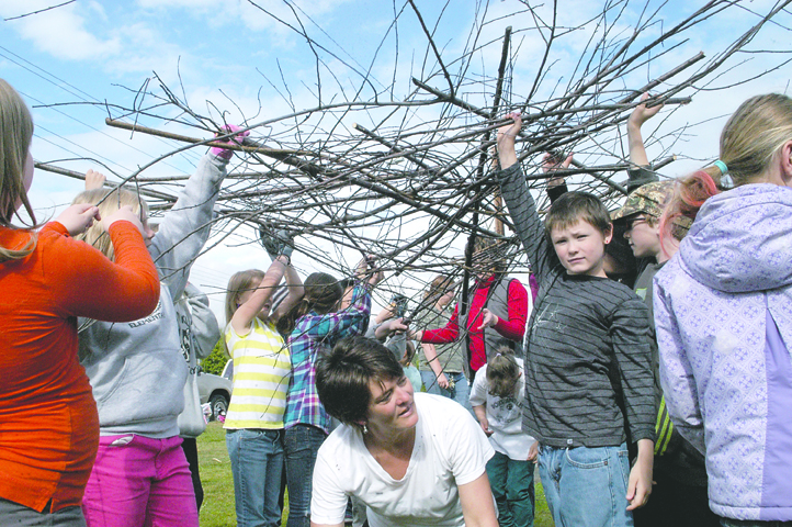 Students from three third-grade classes at Franklin Elementary School in Port Angeles lift a “bird's nest” in progress