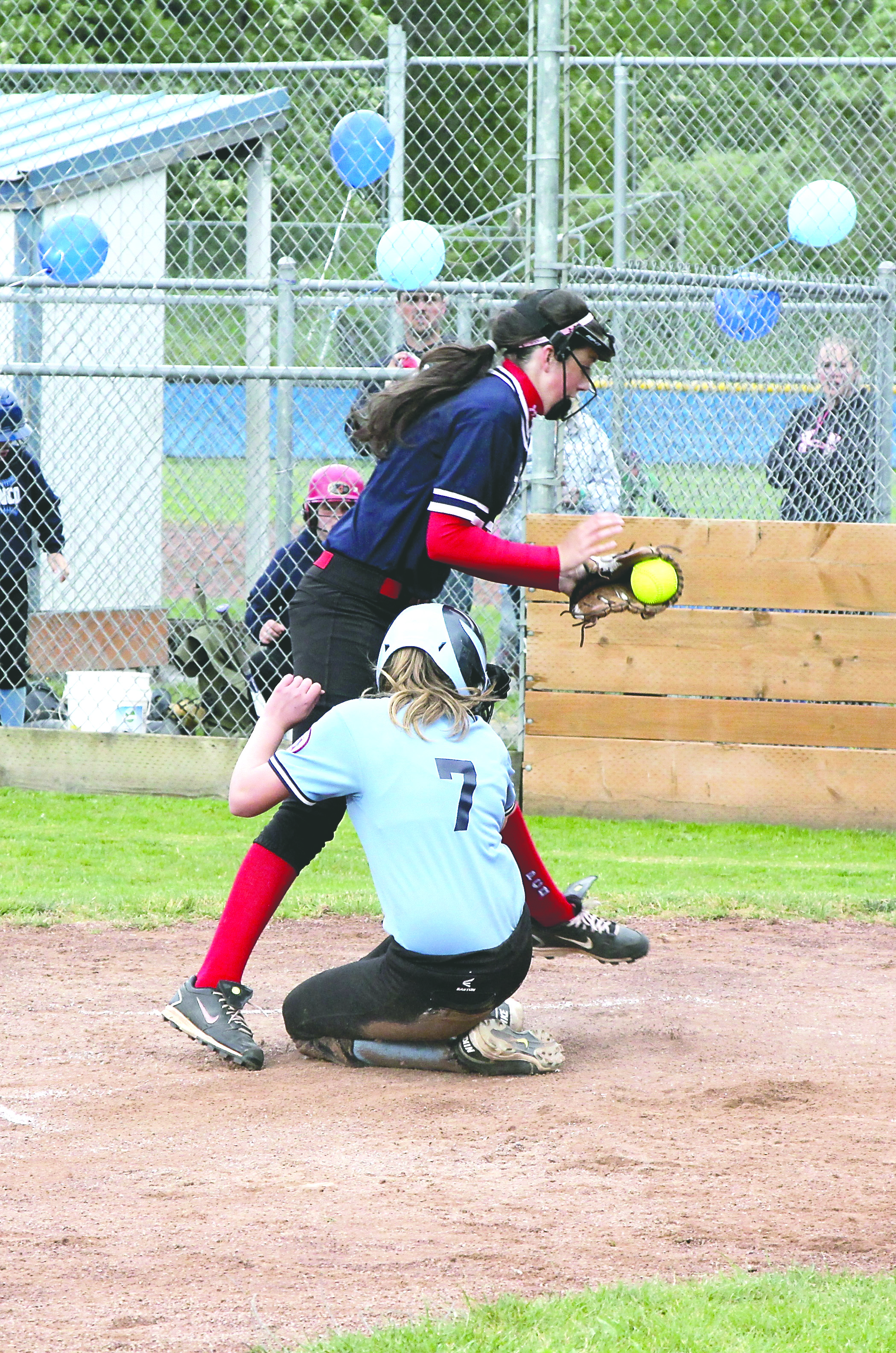 Tranco's Krysten McGuffey (7) slides safely into home plate under the tag of Paint & Carpet Barn pitcher Aeverie Politika to tie the game at 3-3. Paint & Carpet Barn won the game 13-3. Dave Logan/for Peninsula Daily News