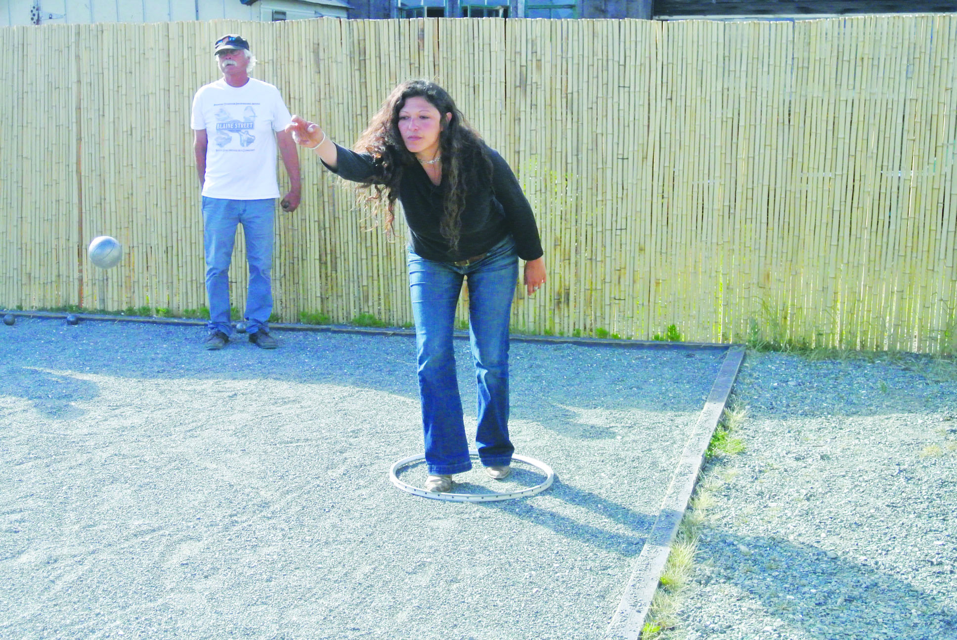 Angelique Garcia throws the boule as Robert Force watches at left at the Pourhouse in Port Townsend. Charlie Bermant/Peninsula Daily News