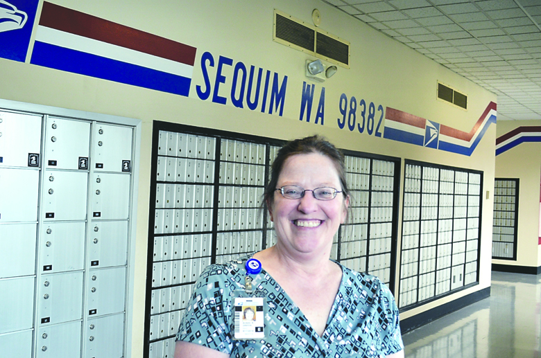 Susan Griffin took over as the new postmaster of the Sequim Post Office last week. She says she is working to reduce daily long lines. Joe Smillie/Peninsula Daily News