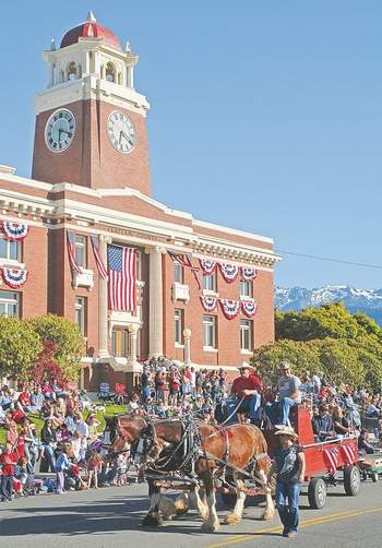 A team of horses pulls one of the many Fourth of July parade entries down Lincoln Street in Port Angeles in 2011. Peninsula Daily News