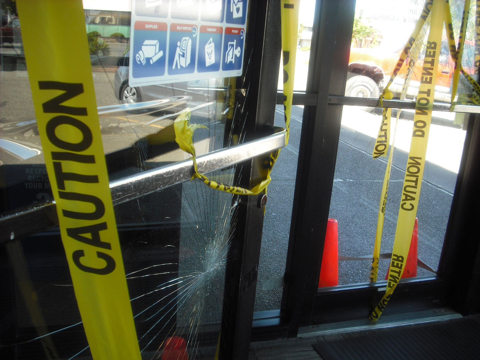 Yellow caution tape remains at the Port Angeles Post Office on Saturday