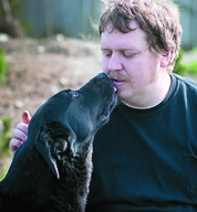 Steve Markwell with one of the dogs he rescued at the Olympic Animal Sanctuary in Forks.