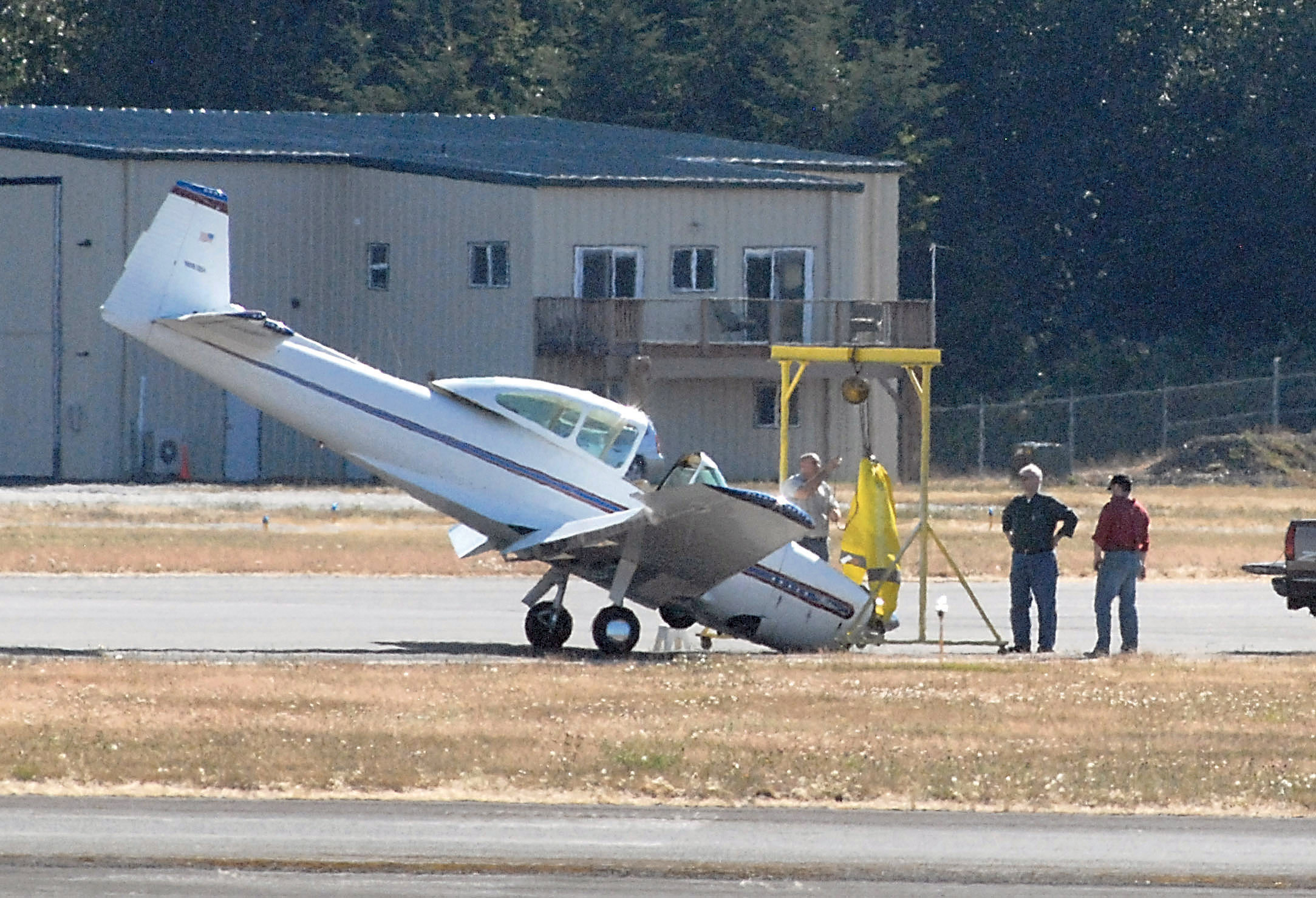 Rite Bros. Aviation workers begin hoisting the nose of a single-engine aircraft at William R. Fairchild International Airport in Port Angeles on Tuesday afternoon. Keith Thorpe/Peninsula Daily News