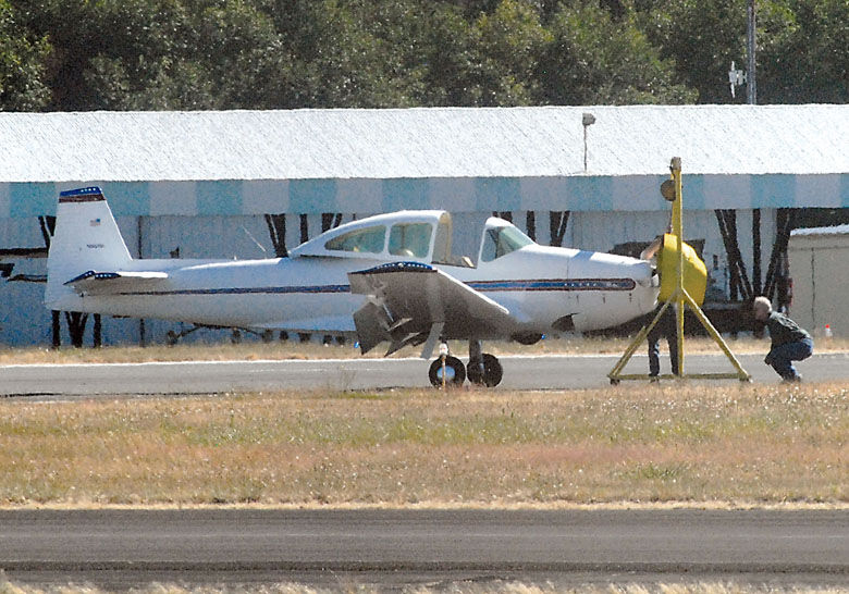 A small plane with its front end hoisted in a sling sits on Runway 26 of William R. Fairchild International Airport in Port Angeles after suffering problems with the nose gear Tuesday. Keith Thorpe/Peninsula Daily News