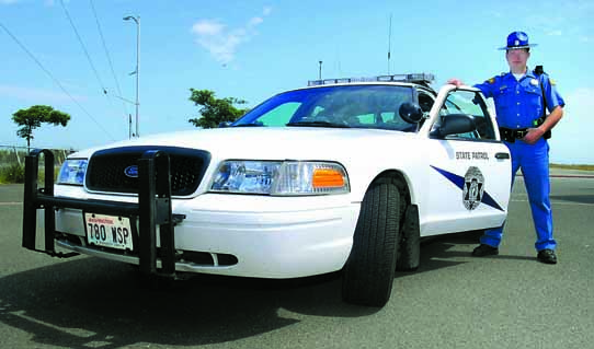 State Patrol Trooper Allen Nelson with his Crown Victoria Police Interceptor. Keith Thorpe/Peninsula Daily News