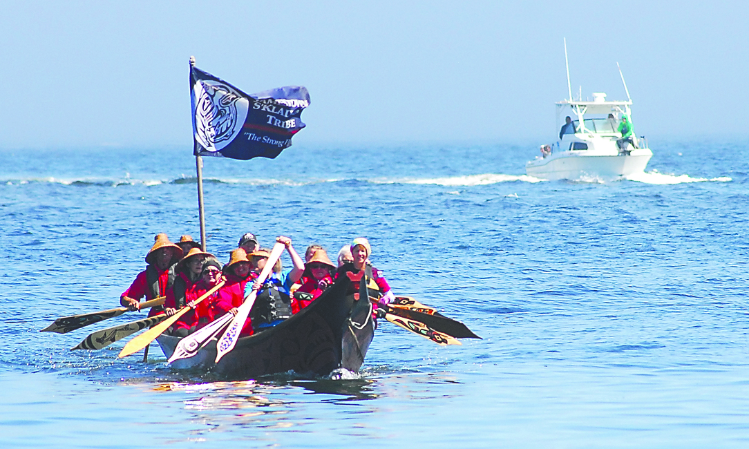 A canoe of the Jamestown S'Klallam tribe is followed by a support boat as it crosses Port Angeles Harbor on Tuesday. Keith Thorpe/Peninsula Daily News