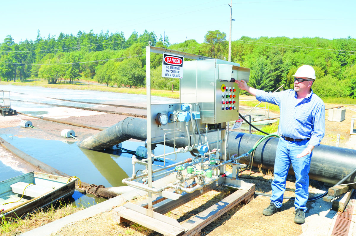 Port Townsend Paper Corp. spokesman Kevin Scott explains Monday the use of a new system meant to decrease the mill's odors. Charlie Bermant/Peninsula Daily News