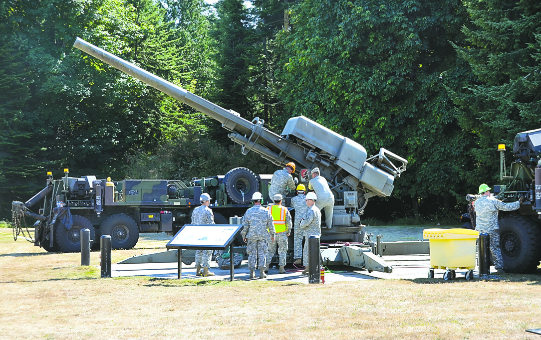 Army National Guard troops work to take apart the giant anti-aircraft gun at Fort Flagler for removal to Camp Murray. Charlie Bermant/Peninsula Daily News