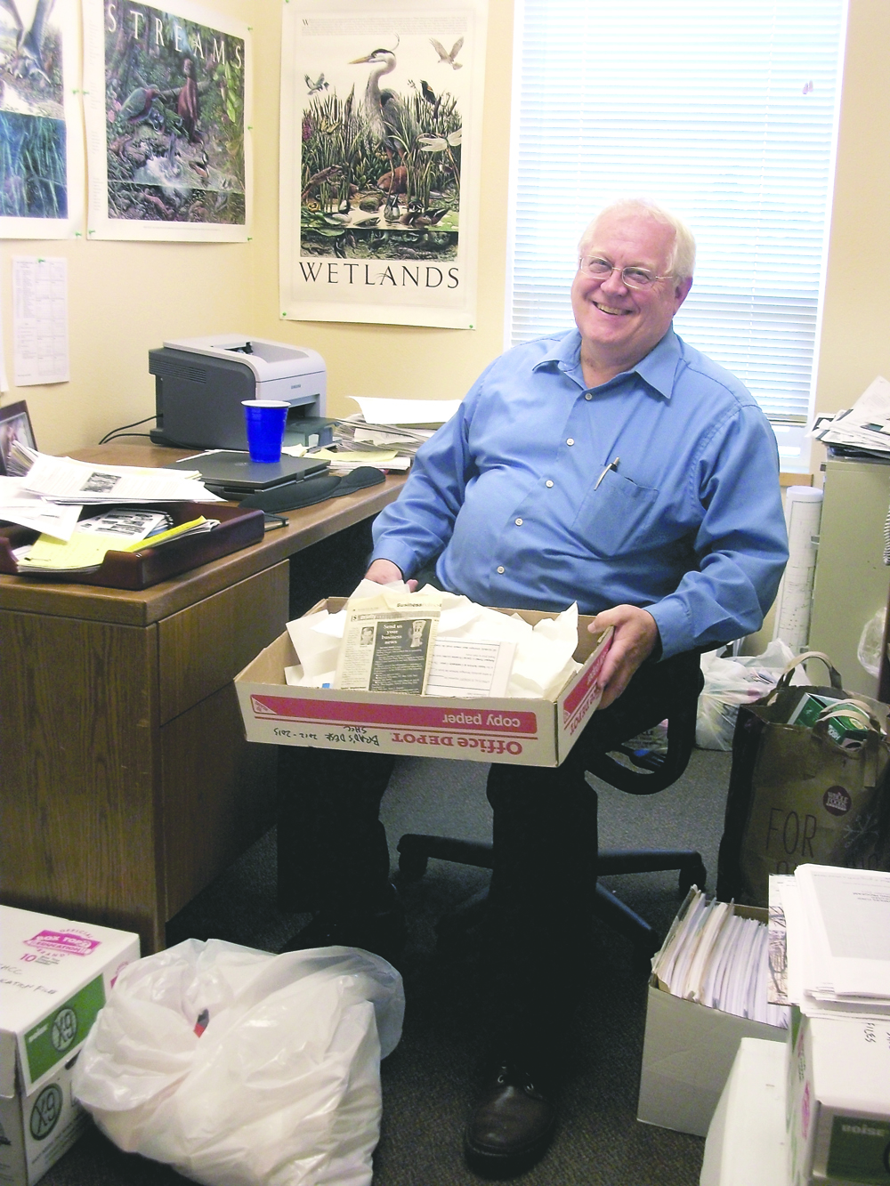 Brad Collins cleans out his office at Serenity House of Clallam County on Monday after announcing his retirement as the Port Angeles nonprofit's deputy director for resource development and capital projects. Serenity House of Clallam County