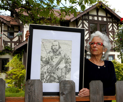 Betsy Reed Schultz holds a pencil drawing by Justin Schafer of Schultz's late son