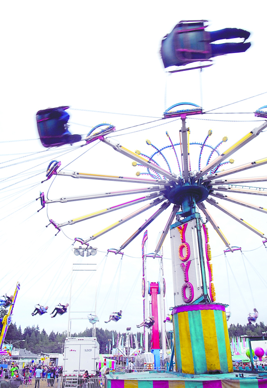 Carnival-goers swing high into the sky on the YoYo ride last weekend at the Clallam County Fair in Port Angeles. Keith Thorpe/Peninsula Daily News