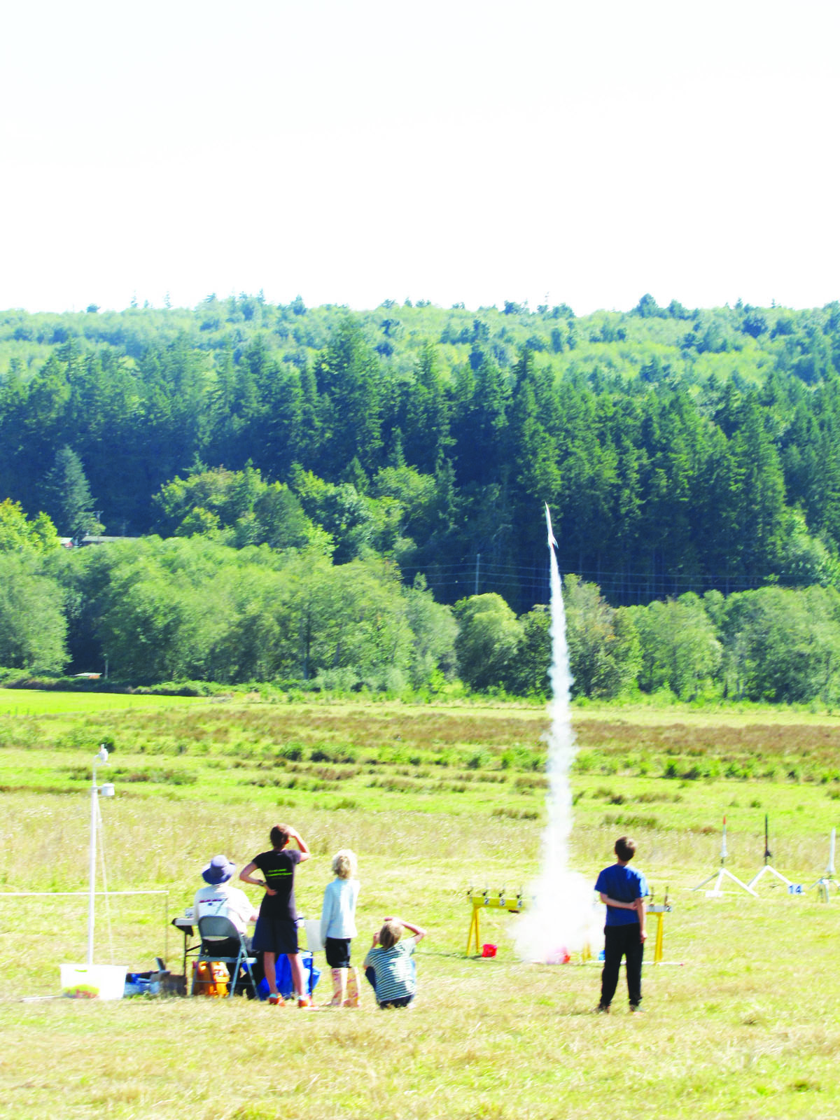 Rocket enthusiasts watch a model blast off during the "Pasture Blaster" event Sunday in Port Townsend. Arwyn Rice/Peninsula Daily News