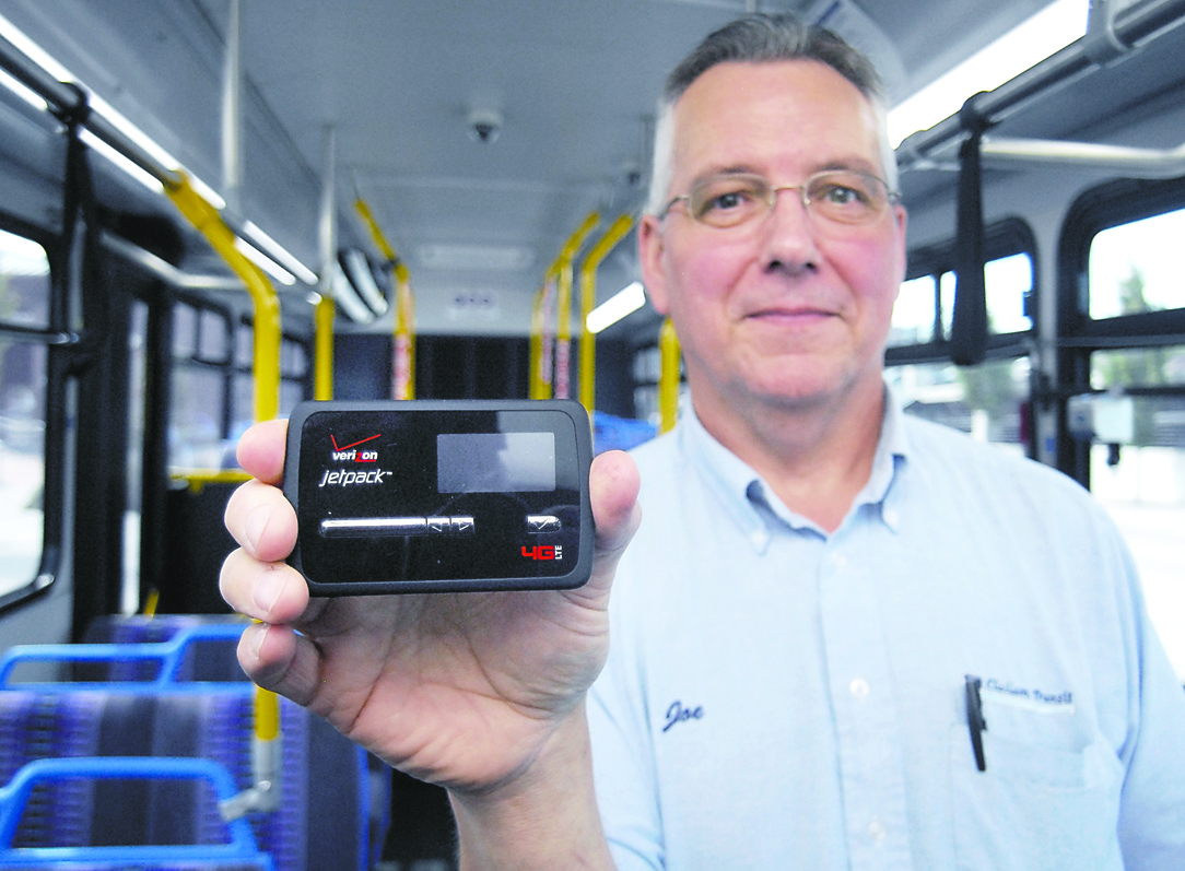 Clallam Transit driver Joe Sutton holds a Verizon Jetpack mobile hot spot being tested to provide Internet access for riders on commuter bus routes Keith Thorpe/Peninsula Daily News