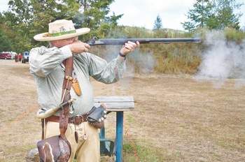 Will Ulry of Olympia fires his muzzleloader at a metal turkey target on the range at the Slab Camp grounds south of Sequim during 2010's Mountain Man Rendezvous. Peninsula Daily News file photo