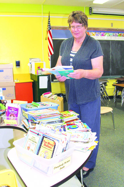 Hamilton Elementary School reading teacher Gloria Mandery sorts through hundreds of reading books in her classroom Wednesday