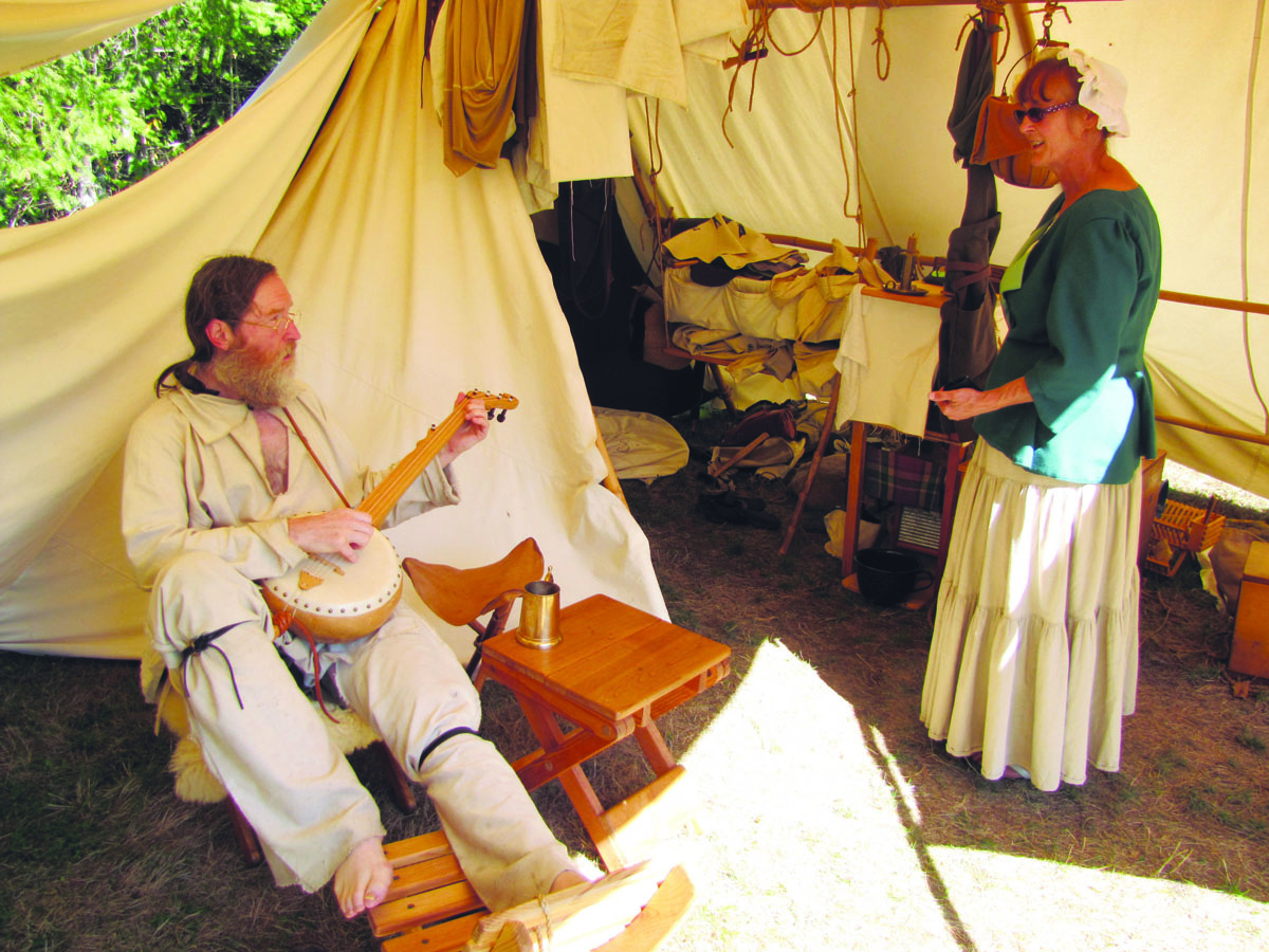 Eric Sisk of Seattle and Donna Helgeson of Sedro-Woolley re-enact old days in the hills above Sequim on Sunday. Arwyn Rice/Peninsula Daily News