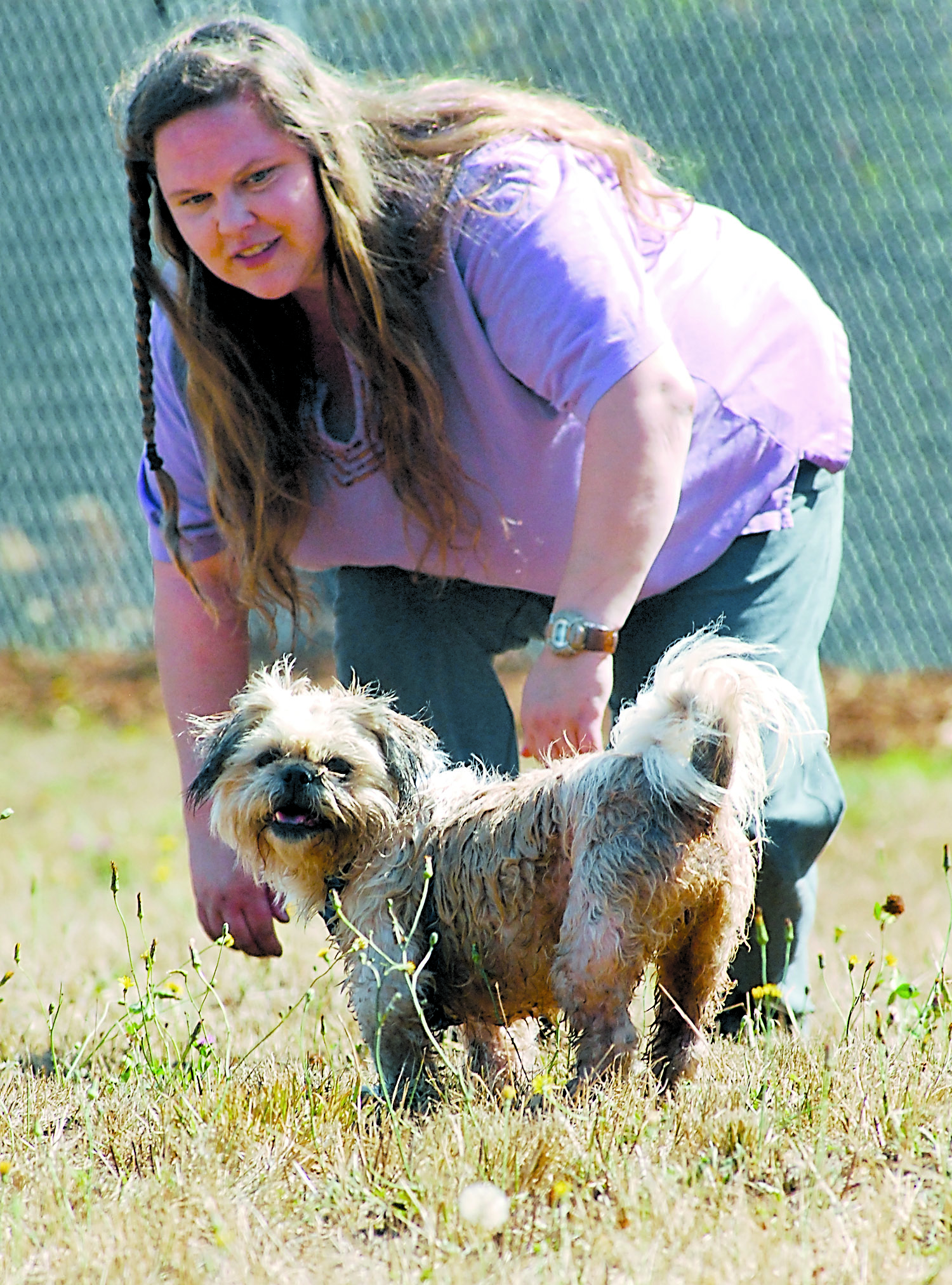 Deja Hill of Port Angeles plays with her dog