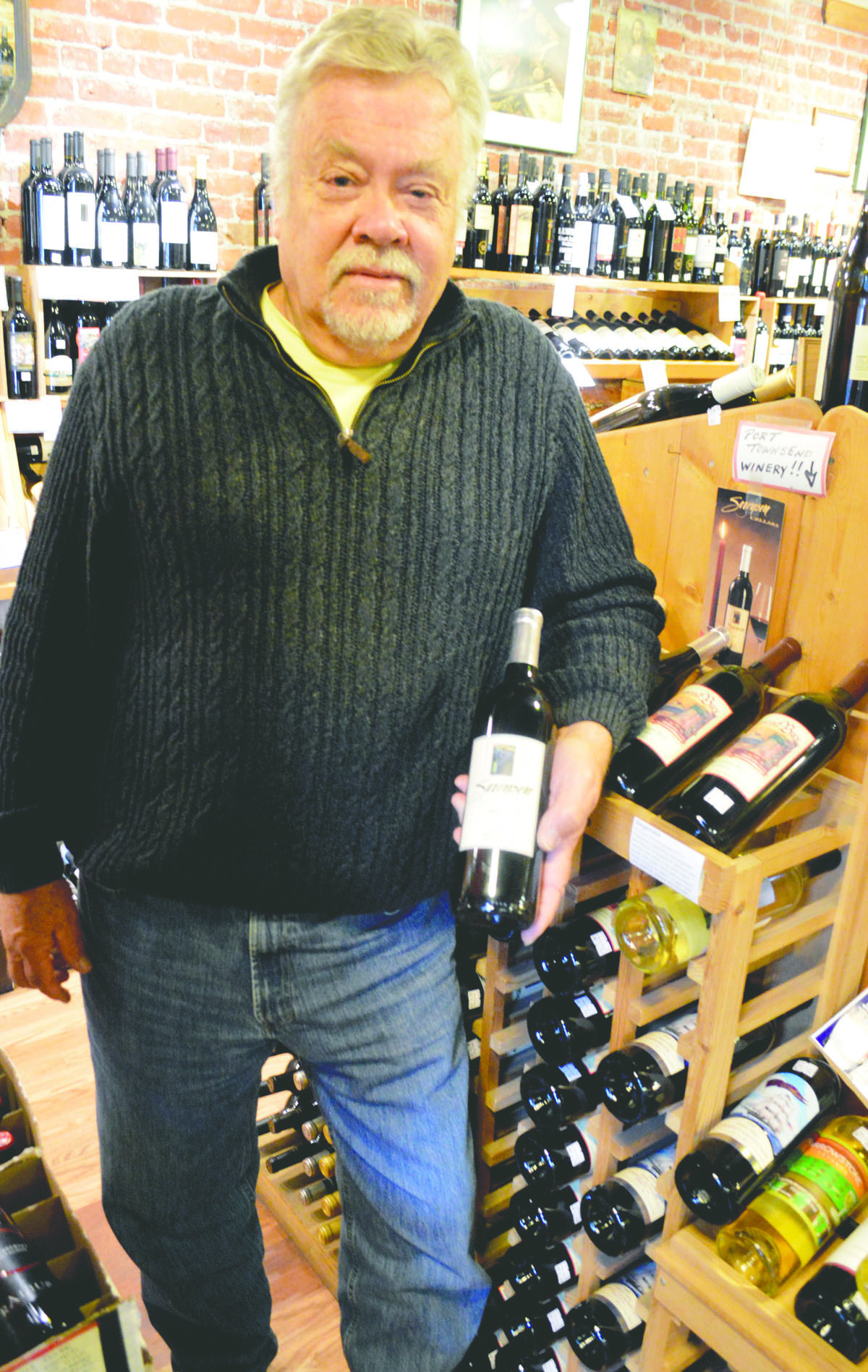 Richard Sorensen shows off some of his wine for sale at The Wine Seller in Port Townsend. Joe Smillie/Peninsula Daily News