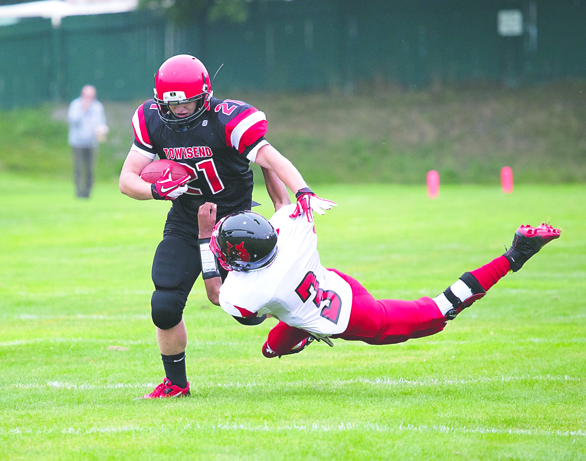 Port Townsend's Tim Russell breaks the tackle of Coupeville's Tyree Booker and rushes for first down in the opening quarter of the Redskins' 41-0 win at Memorial Field. Steve Mullensky/for Peninsula Daily News