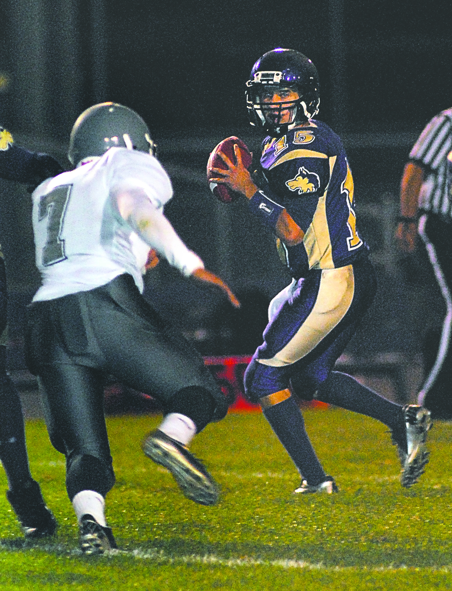 Sequim quarterback Miguel Moroles looks to pass as River Ridge lineman Gabe Fraser closes in. Keith Thorpe/Peninsula Daily News