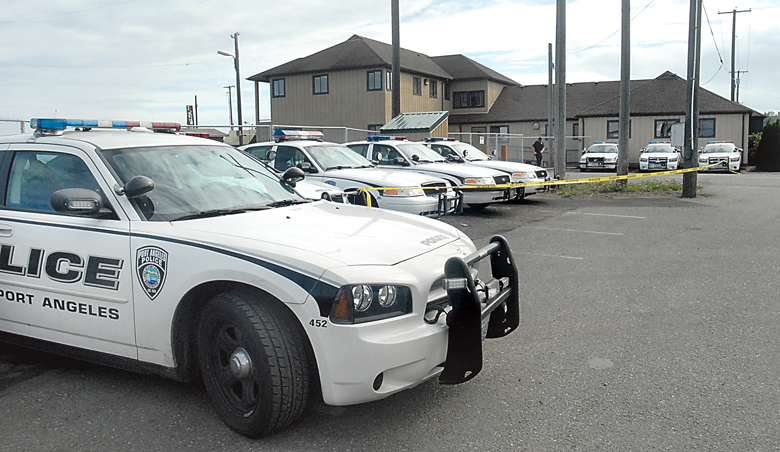 A line of Port Angeles police cruisers sits near the administrative office building during a training session at the site of the former Peninsula Plywood mill in Port Angeles on Thursday. Keith Thorpe/Peninsula Daily News