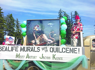 A float carrying Jacob Kohn and one of eight sea life murals he painted that once were displayed at the Seattle Aquarium makes its way down the Quilcene Fair parade route in 2012. The paintings were donated to the community for public display. This year's community fair continues through late Saturday. Greg Brotherton