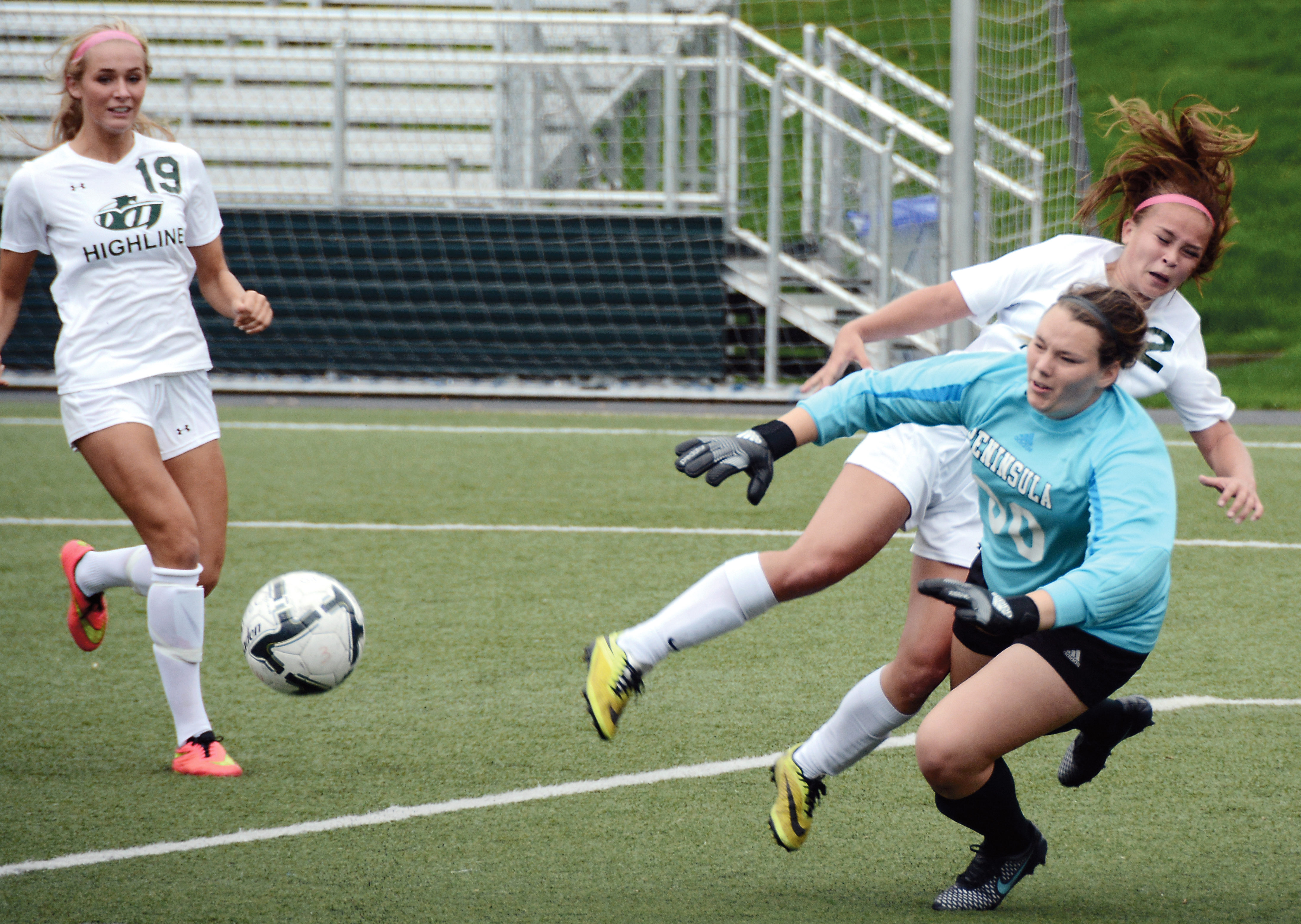 Peninsula College goalkeeper Emily Flinn (00) protects the goal against Highline's Paige Surber