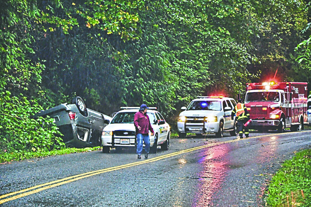 Clallam County Fire District No. 2 responds to a single-car rollover on Lower Elwha Road west of Port Angeles on Monday. Jay Cline