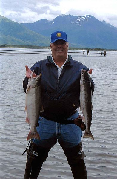 A lucky angler with two bright coho salmon. Wiki Commons