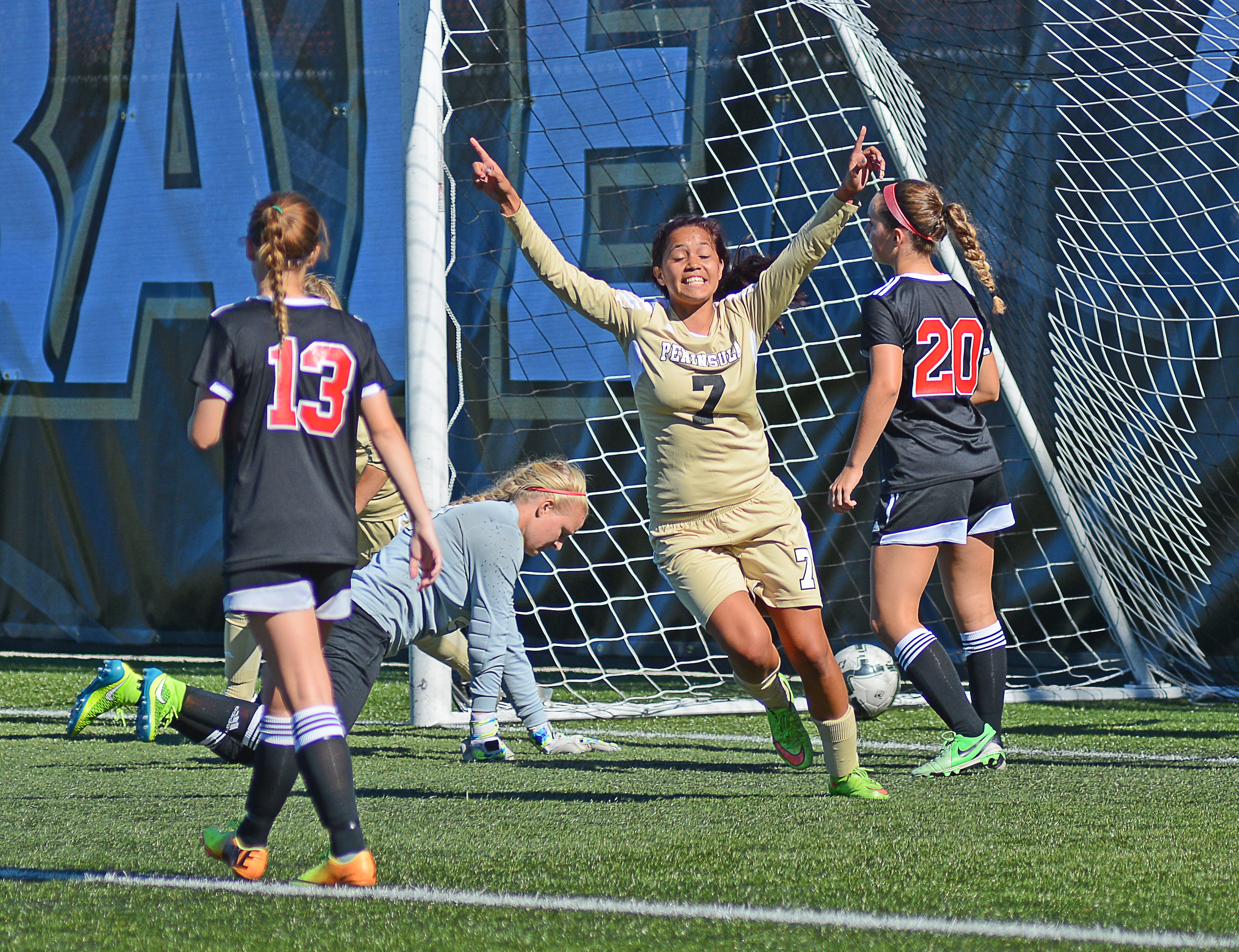 Peninsula's Hoku Afong celebrates after beating Everett goalkeeper Emily Sorenson