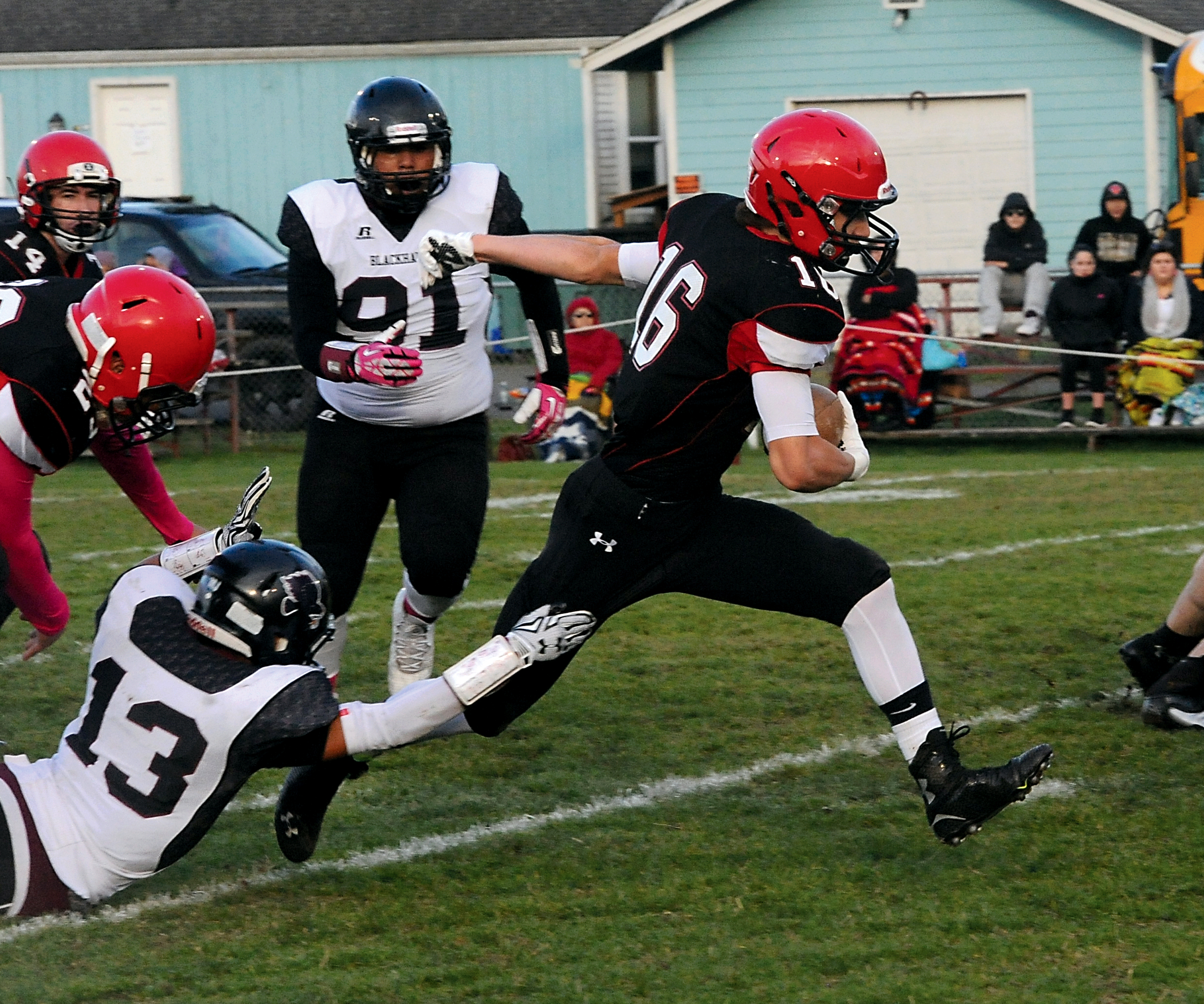 Neah Bay's Cole Svec (16) runs past Lummi's Raven Borsey (13) for a big gain. Lonnie Archibald/for Peninsula Daily News