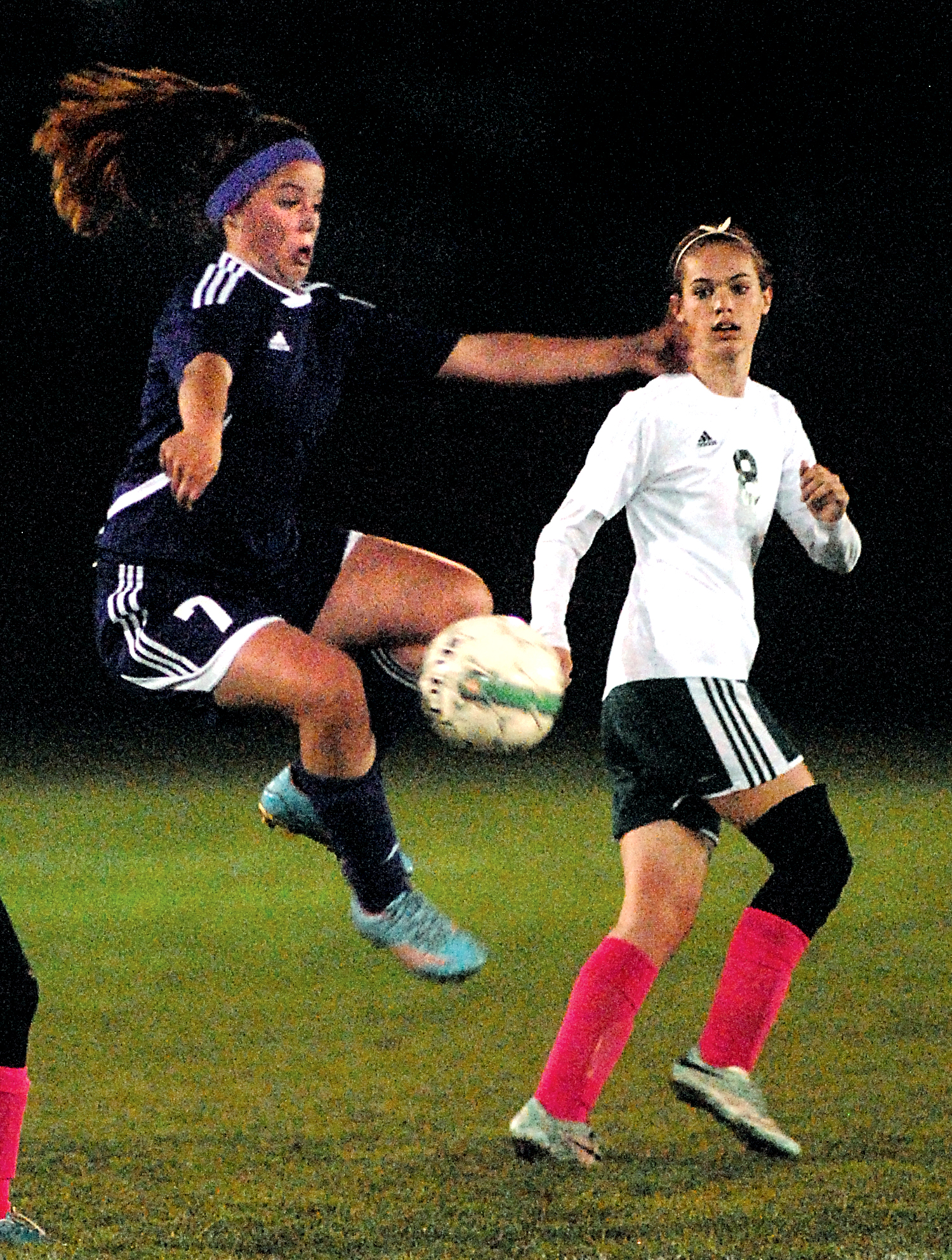 Sequim's Aylee Bennett leaps for a loose ball as Port Angeles' Emma Smith looks on. Keith Thorpe/Peninsula Daily News