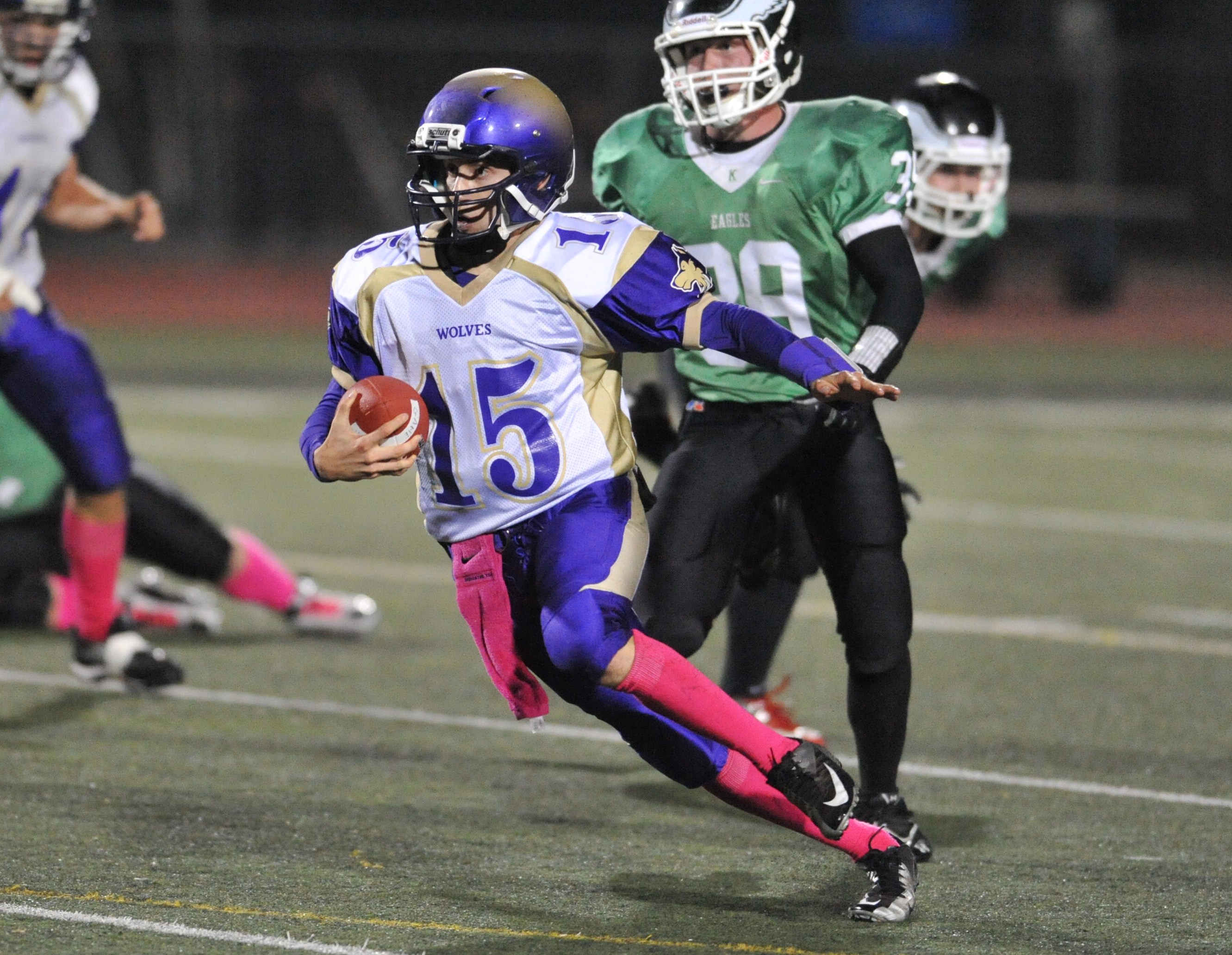 Sequim quarterback Miguel Moroles runs upfield ahead of Klahowya's Eli Everson (39). Jeff Halstead/for Peninsula Daily News