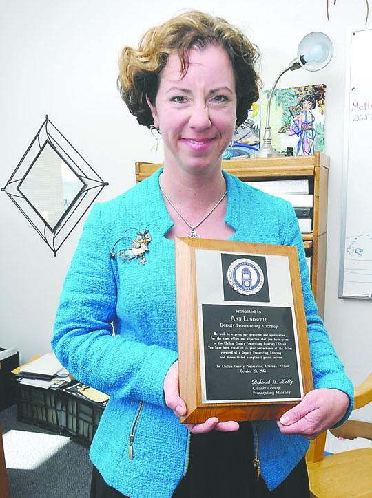 Clallam County Deputy Prosecuting Attorney Ann Lundwall shows off a plaque Tuesday recognizing her service to the county. Keith Thorpe/Peninsula Daily News