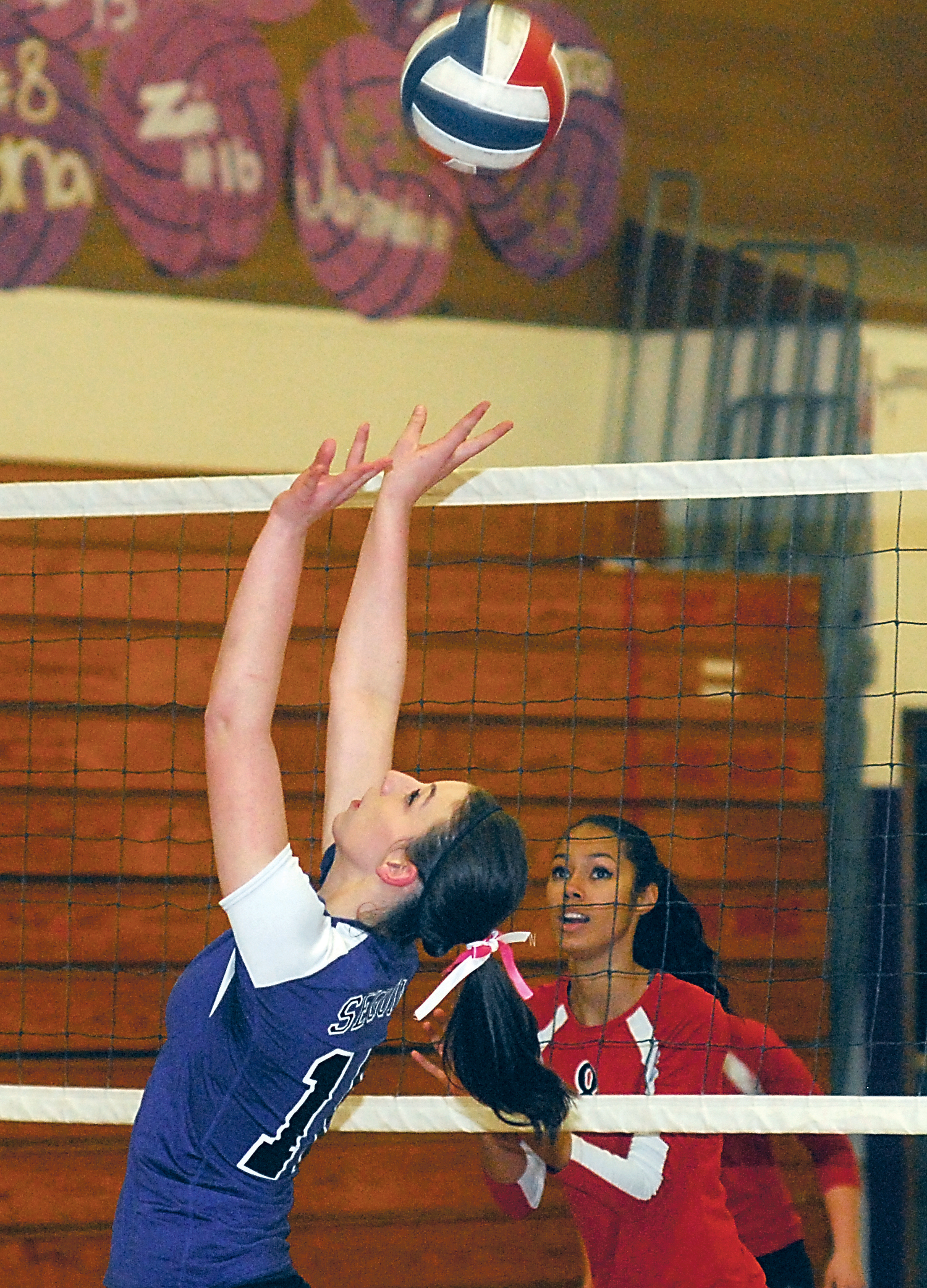 Sequim's Emily Wallner sets the ball as Port Townsend's Trisha Reeves looks on during the first set of their Olympic League match at Sequim High School. Keith Thorpe/Peninsula Daily News