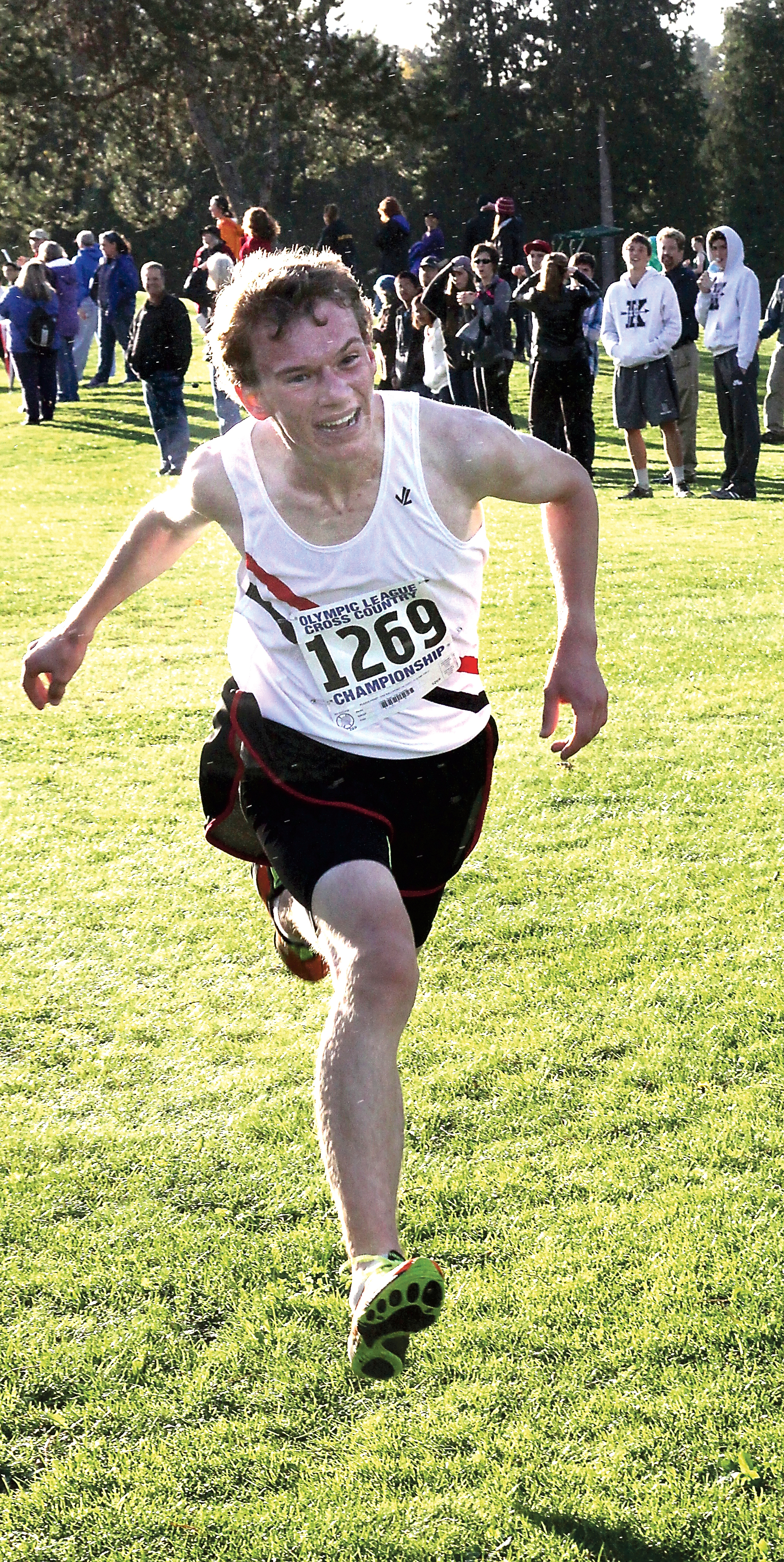 Port Townsend's Ryan Clarke flies across the finish line for a decisive win in the boys race at the Olympic League cross country championship meet at Cedars at Dungeness. Dave Logan/for Peninsula Daily News